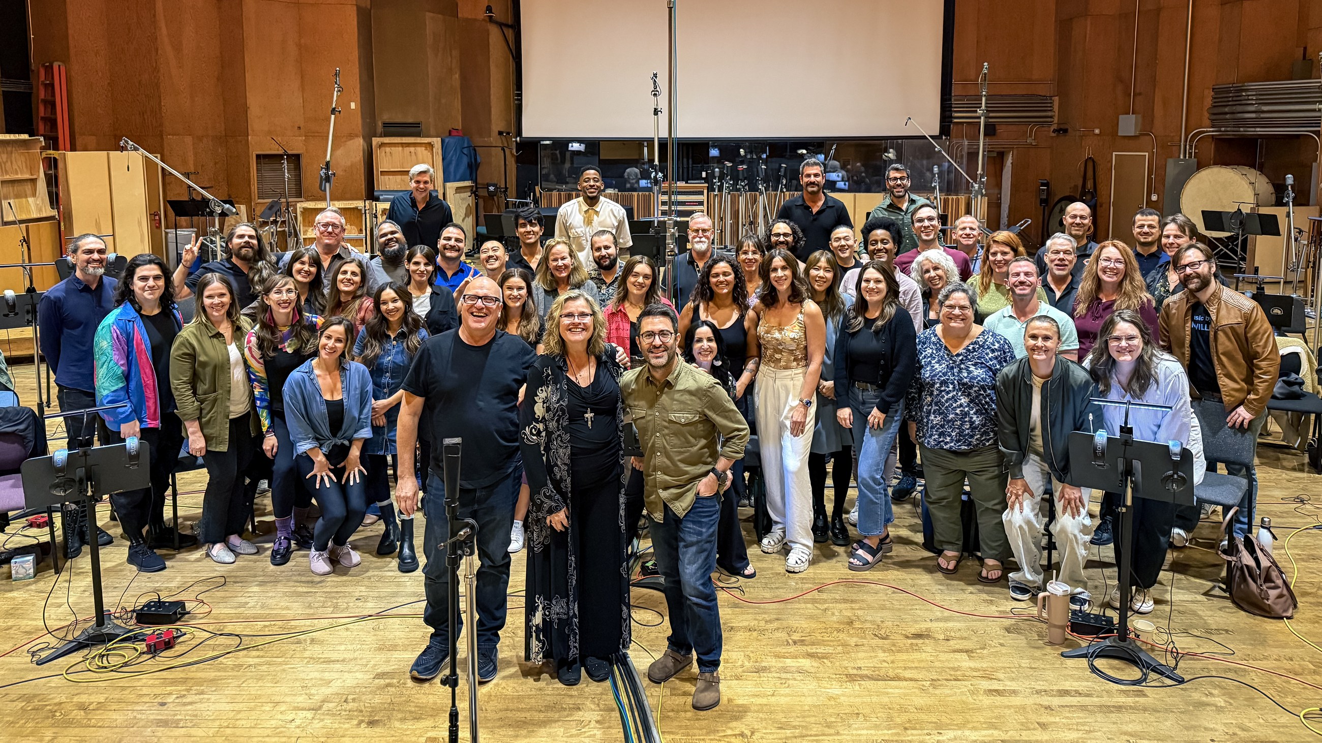 Graham Foote with a large choir in a professional recording studio