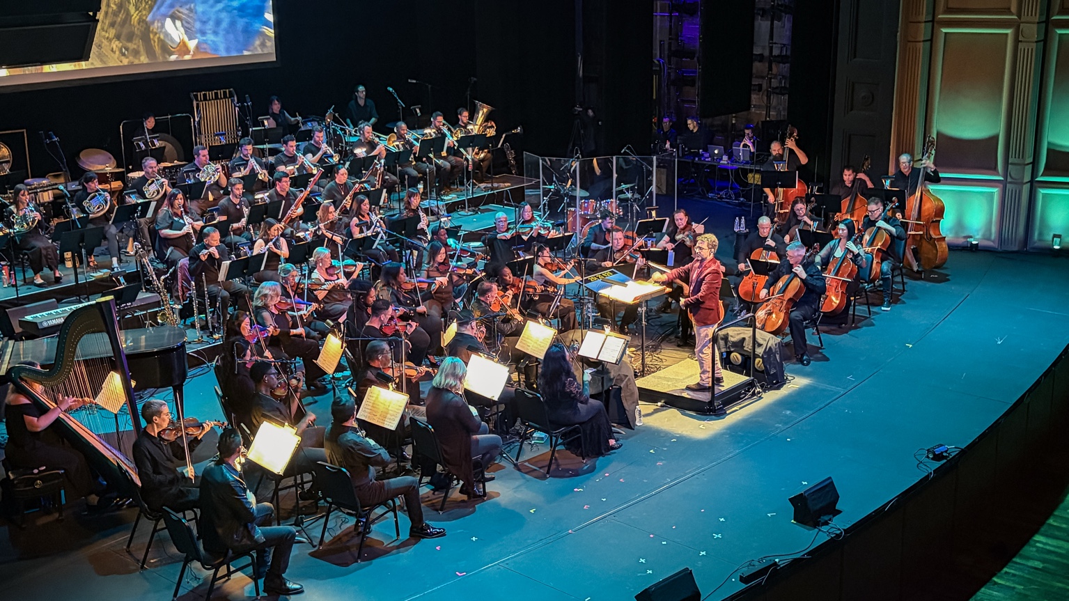 Graham Foote conducting orchestra during a live performance